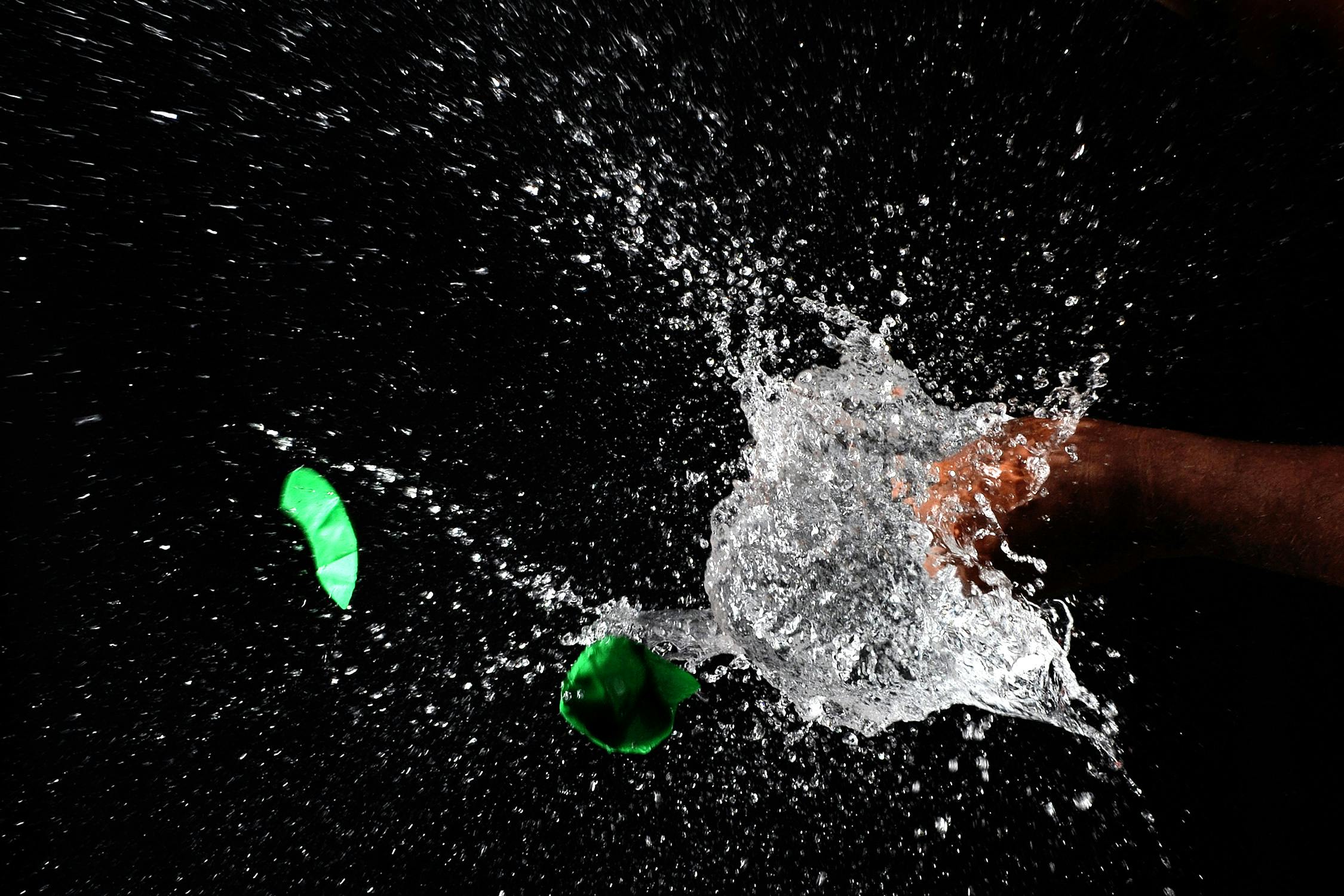 High-speed photograph of water splash capturing motion and liquid dynamics against a dark background.